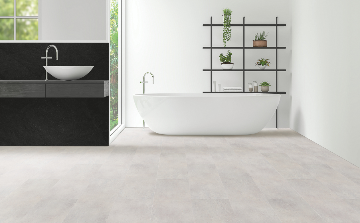 Modern bathroom with gray tile flooring free standing tub and floating vanity